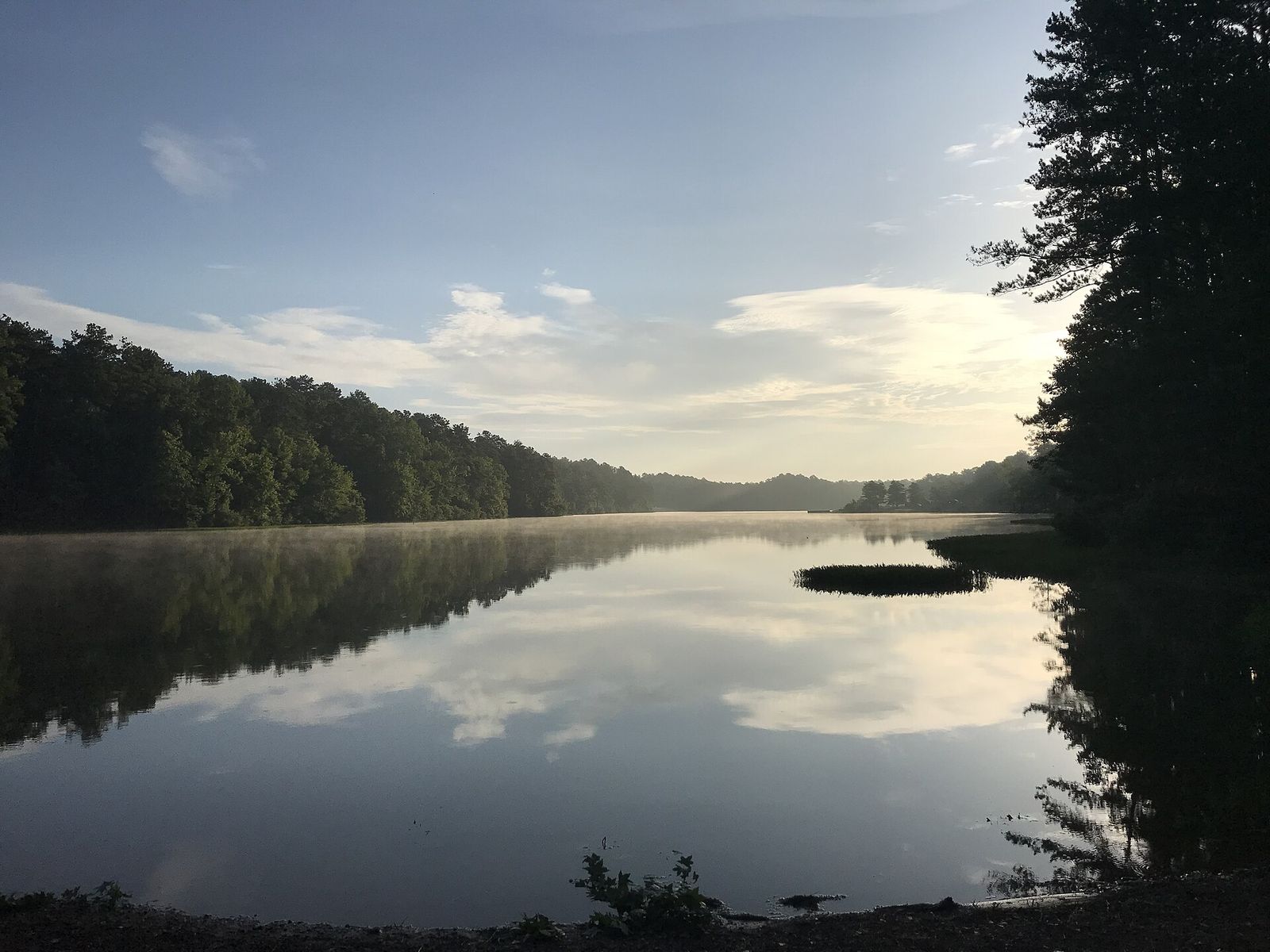 A lake at Oak Mountain State Park in Pelham, Alabama, edged by trees