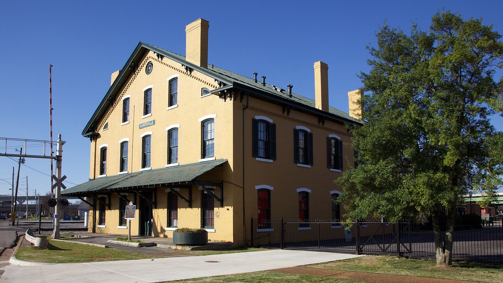 The brick Huntsville Depot beside the railroad tracks, now a railroad museum