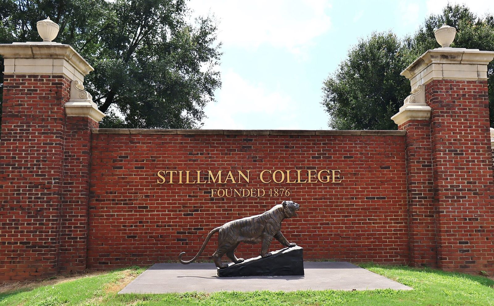 The brick entrance sign of Stillman College in Tuscaloosa, founded in 1876, with a tiger statue in front