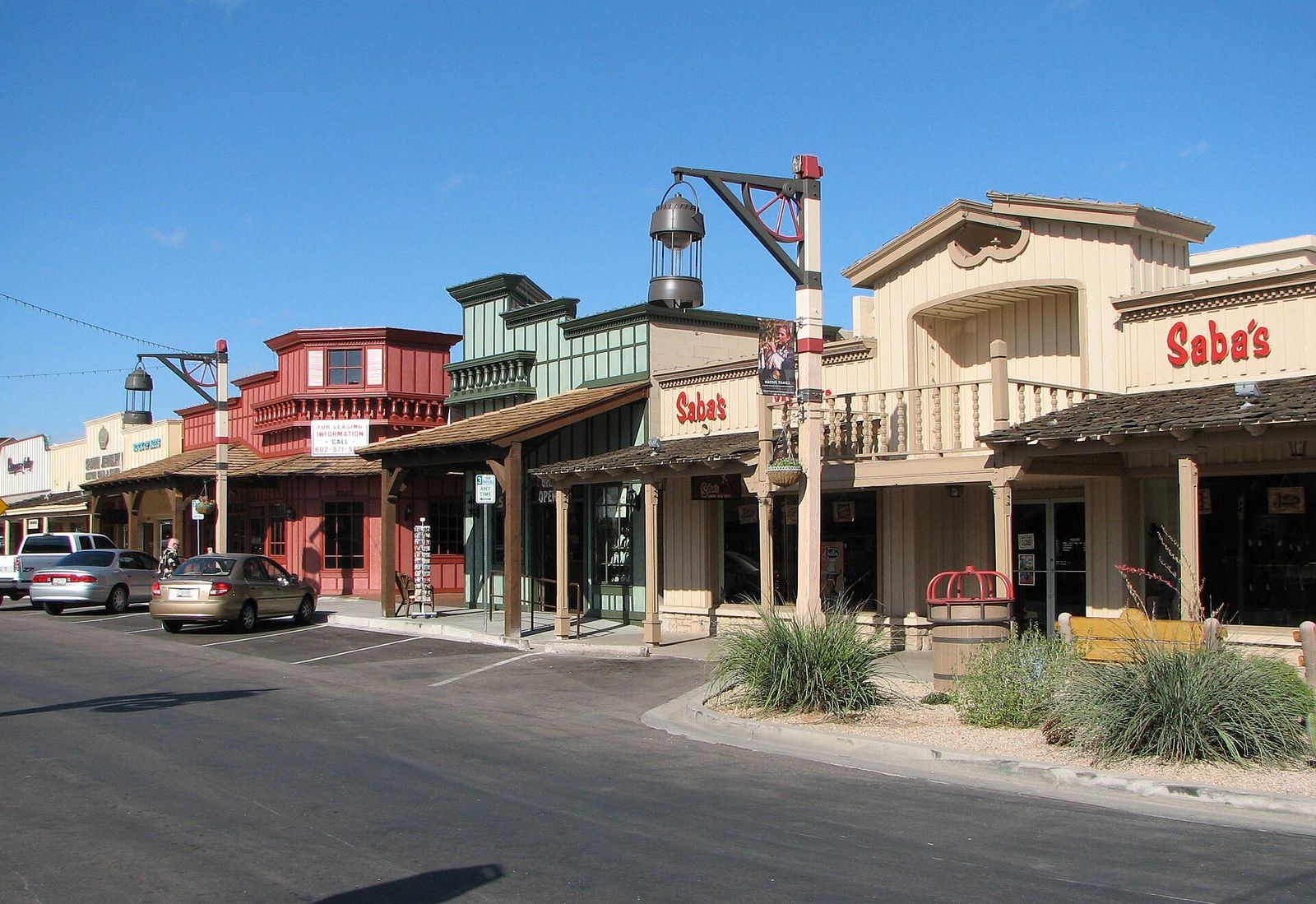 Western-style storefronts with covered porches along a street in Old Town Scottsdale