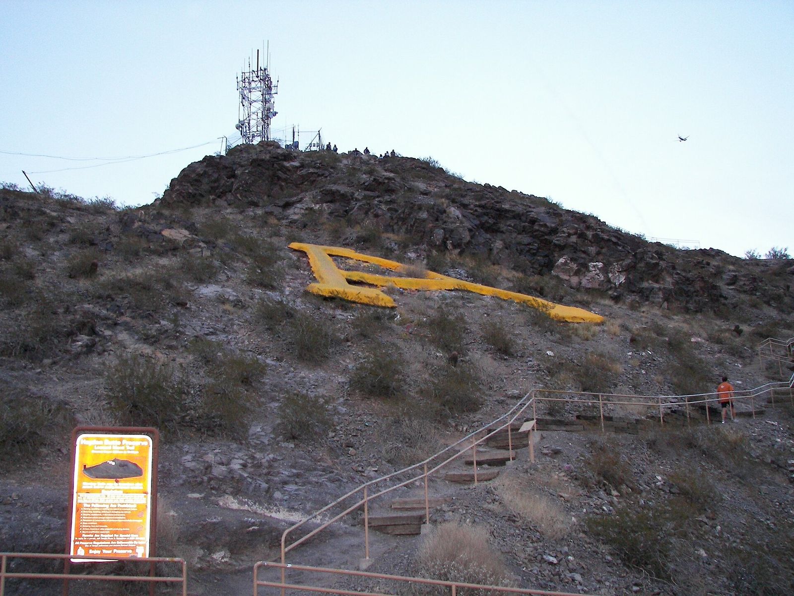Hayden Butte in Tempe, known as A Mountain, with a large gold A on its rocky slope and a path up the side