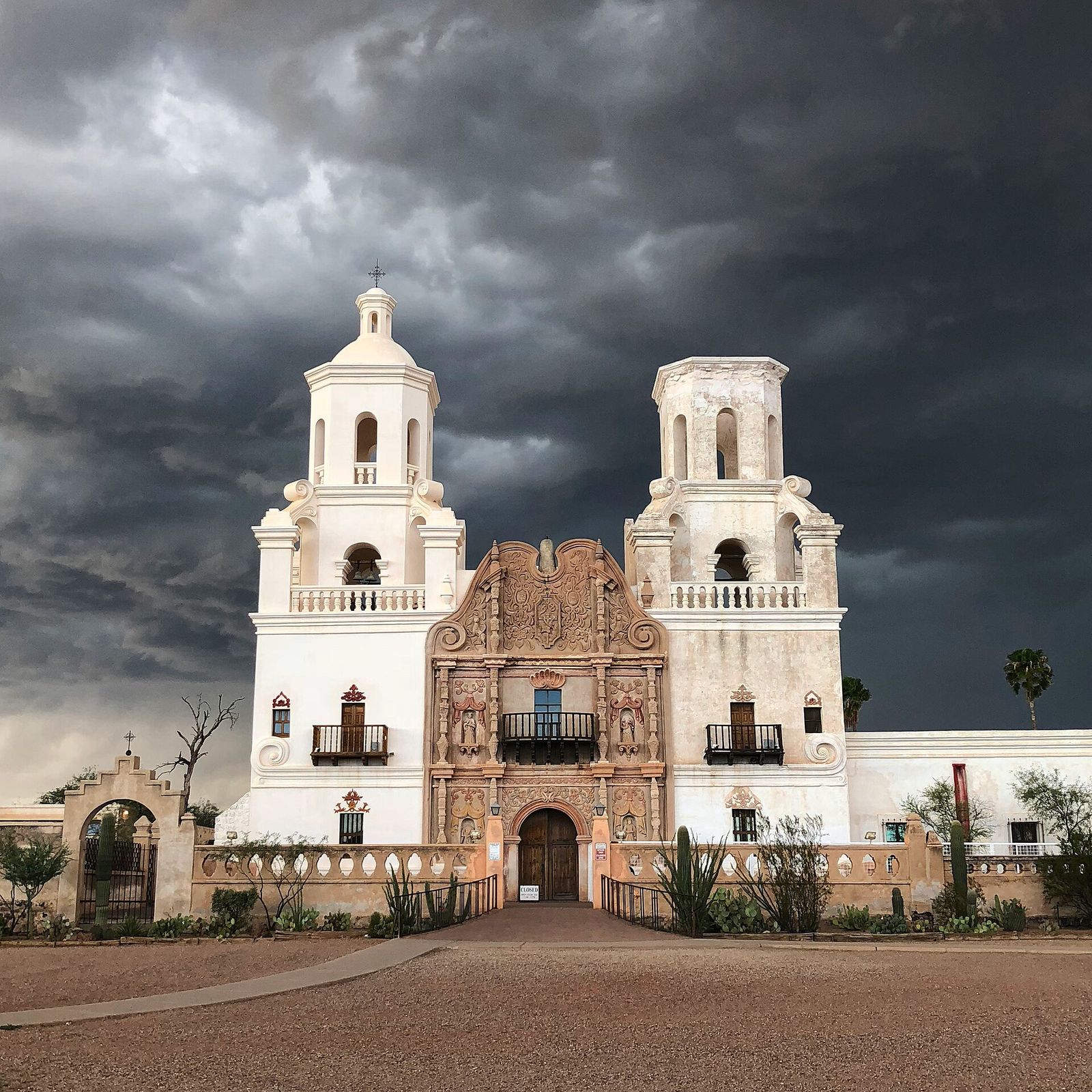 Mission San Xavier del Bac, the white mission church south of Tucson, under a dark stormy sky