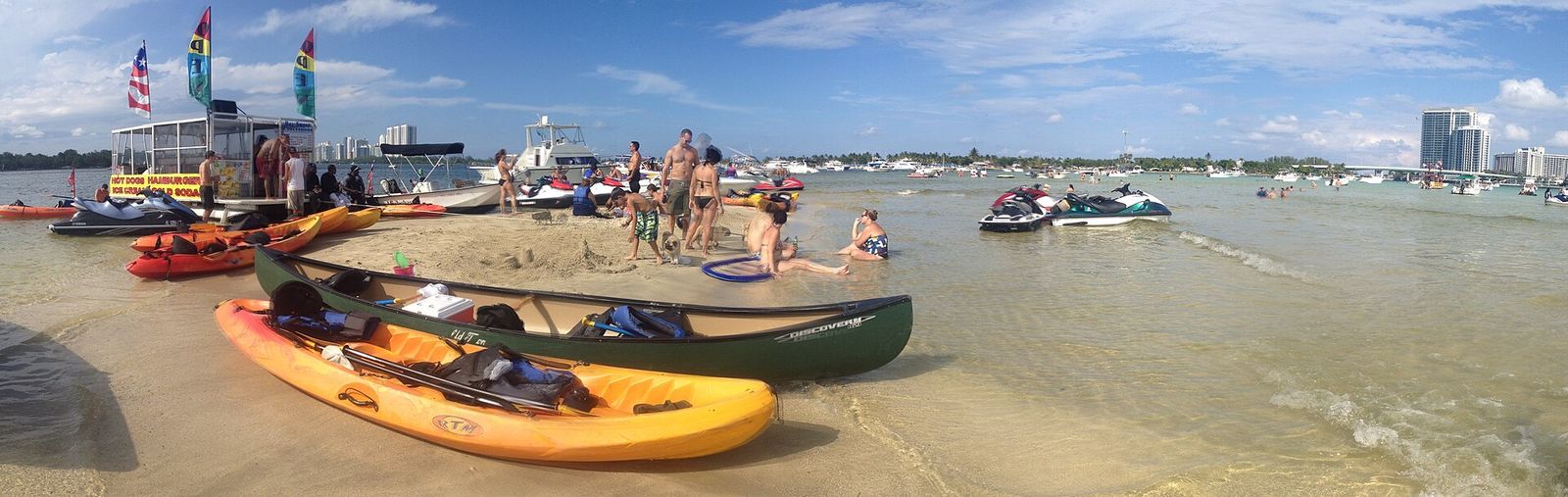 Kayaks, boats and people gathered on a low-tide sandbar in Biscayne Bay between North Miami and Haulover Inlet