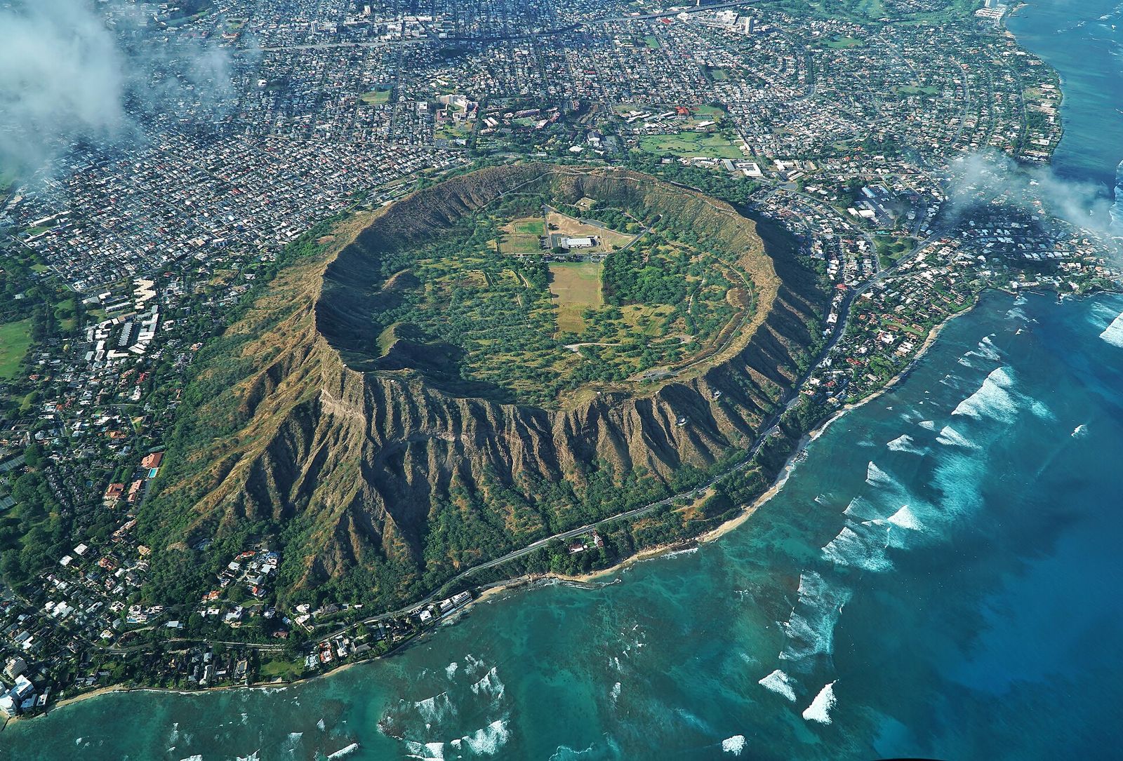 Aerial view of Diamond Head, the dormant volcanic tuff cone in Honolulu, with neighborhoods and the ocean around it