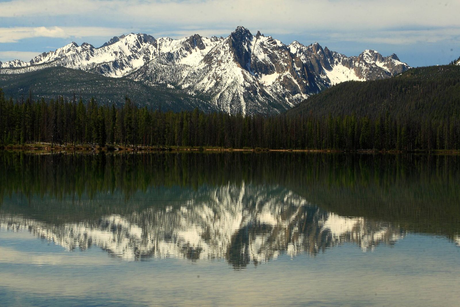 Grand Mogul and nearby Sawtooth peaks reflected in the still water of Little Redfish Lake
