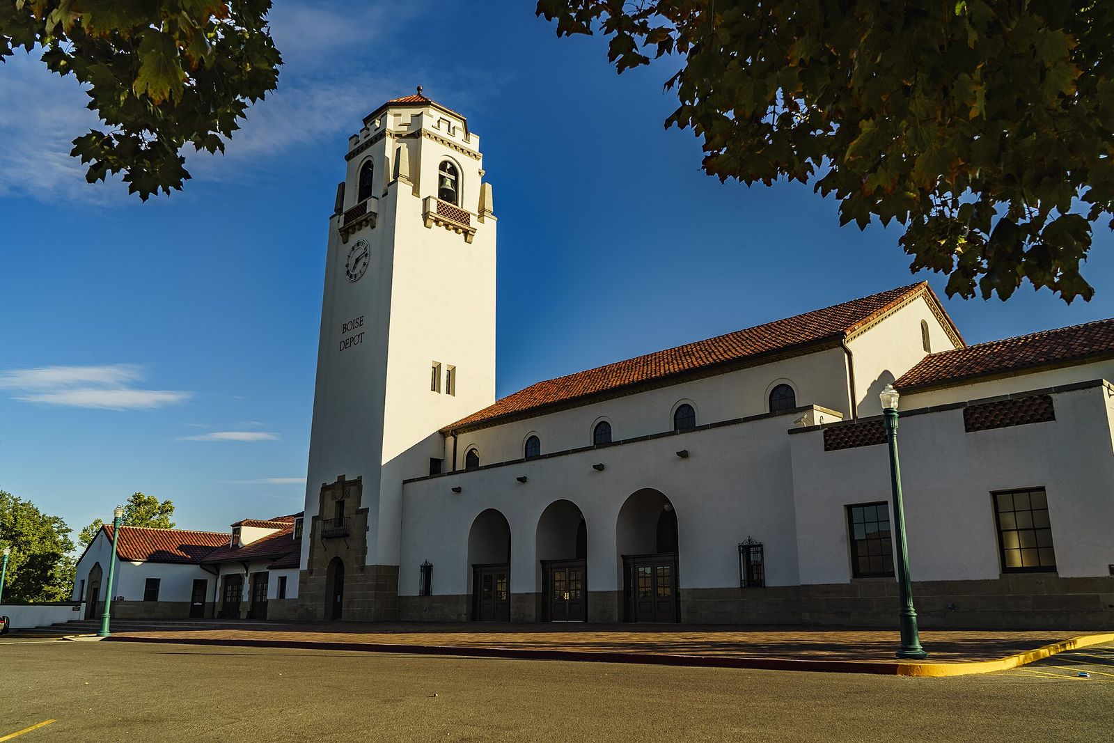 The white Boise Depot with its tall bell tower and red tile roofs under a blue sky