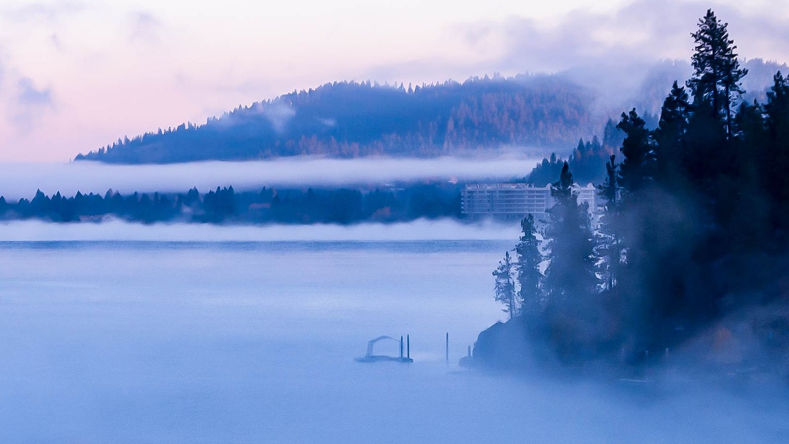 Morning mist lying low over Lake Coeur d'Alene in front of forested hills