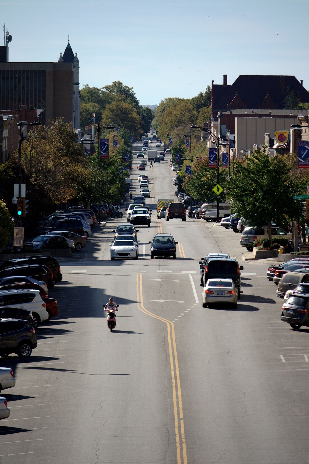 Brick storefronts and traffic along Massachusetts Street in downtown Lawrence