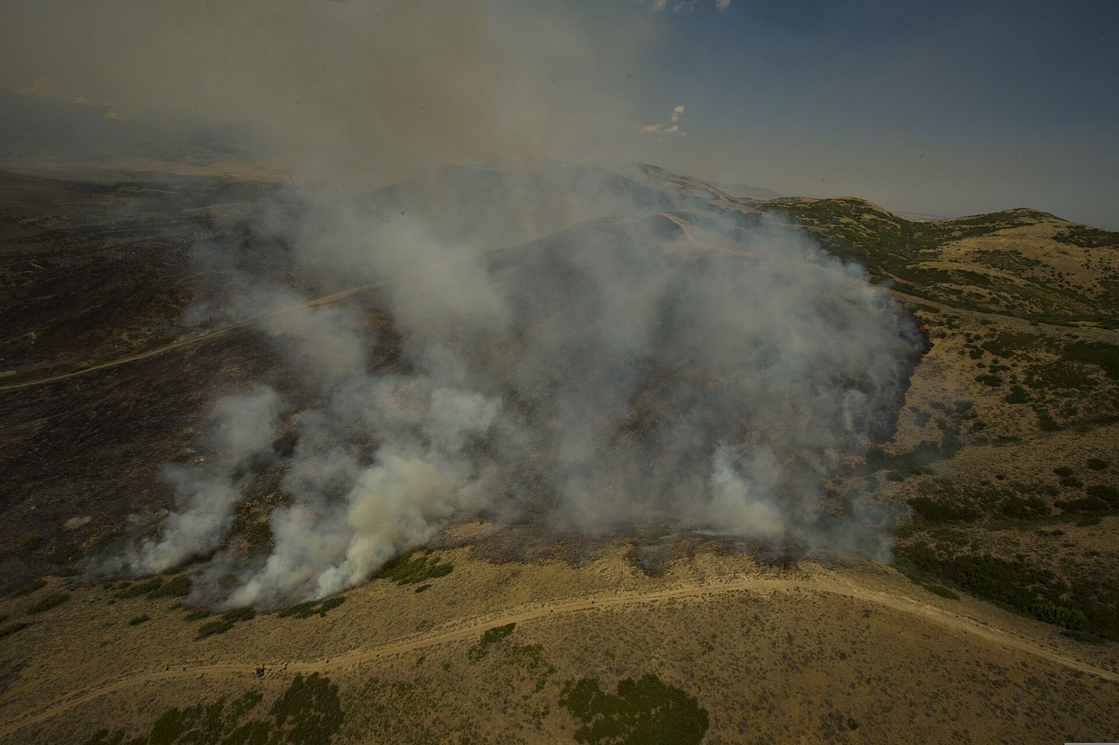 Smoke rising from a grass fire on a hillside at Camp Williams during an August 2012 fire