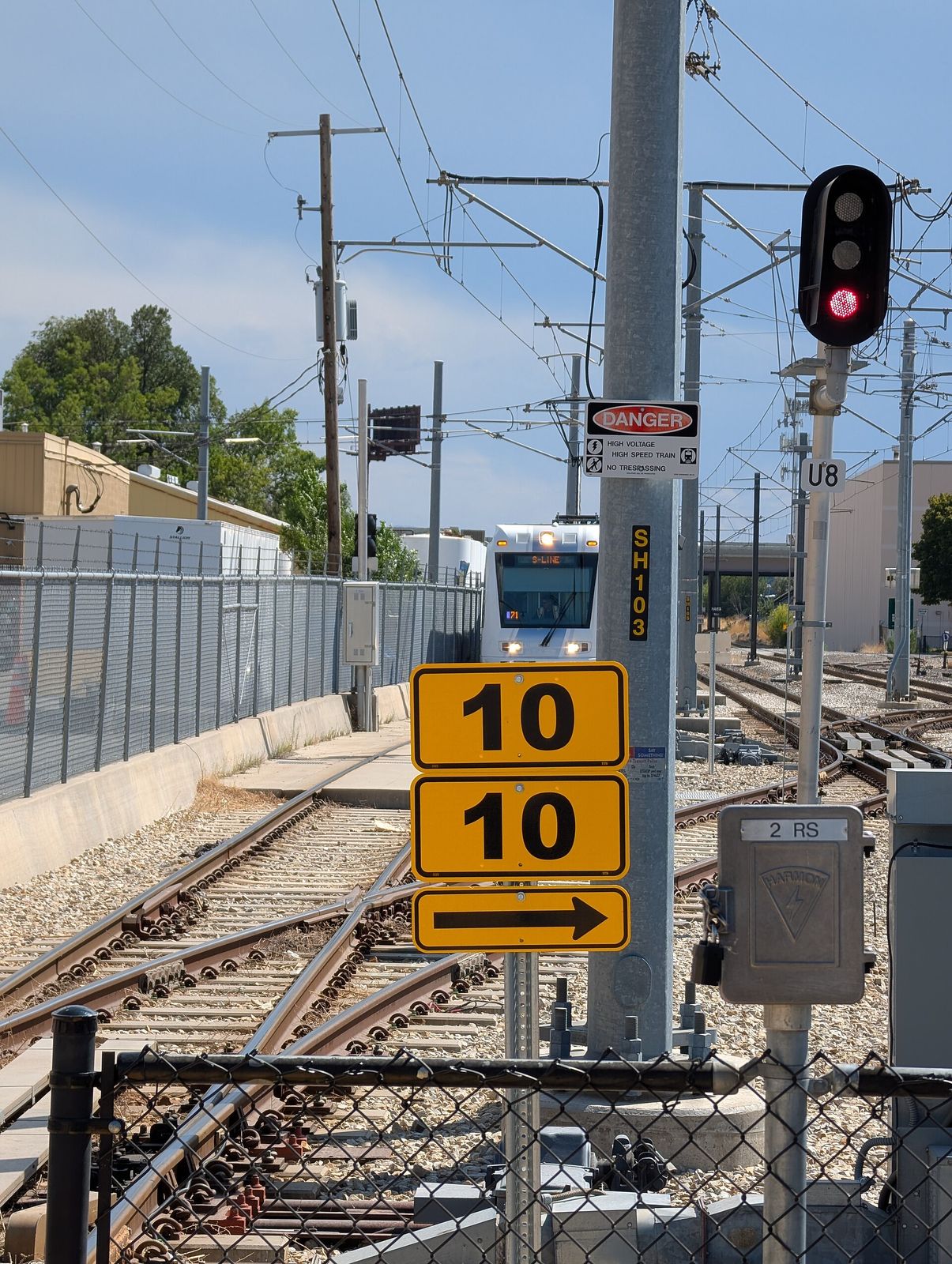 An S Line streetcar pulling into Central Pointe station past the platform signals