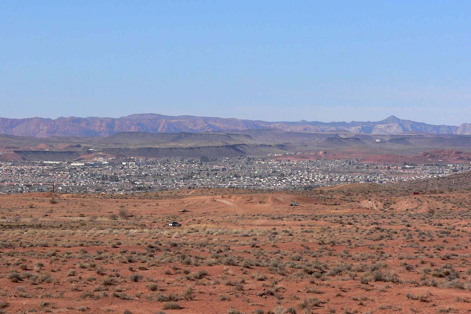 St. George spread across the valley below red desert hills, seen from the east near Punchbowl Dome
