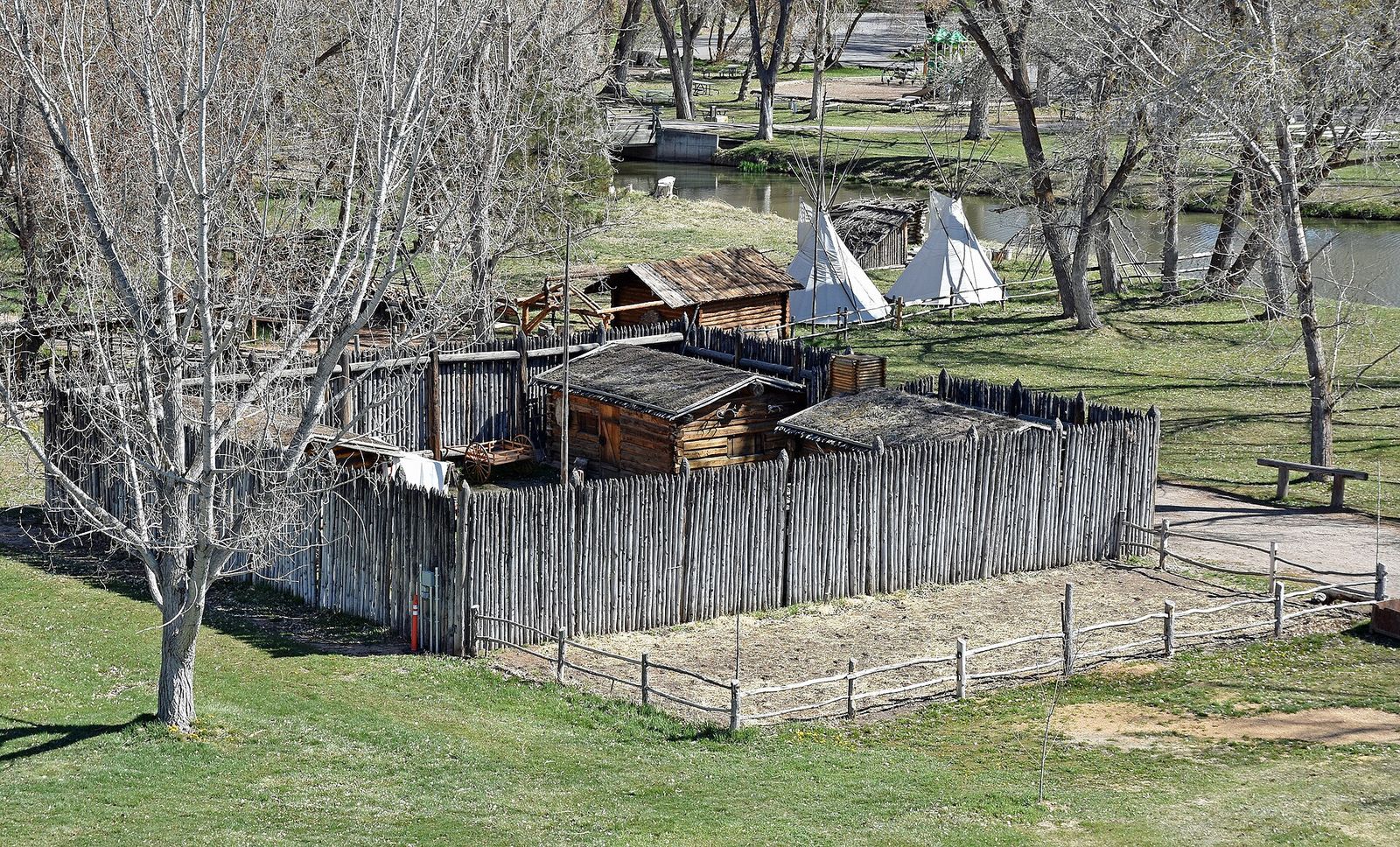 The log stockade of the Fort Buenaventura replica among trees in neighboring Ogden