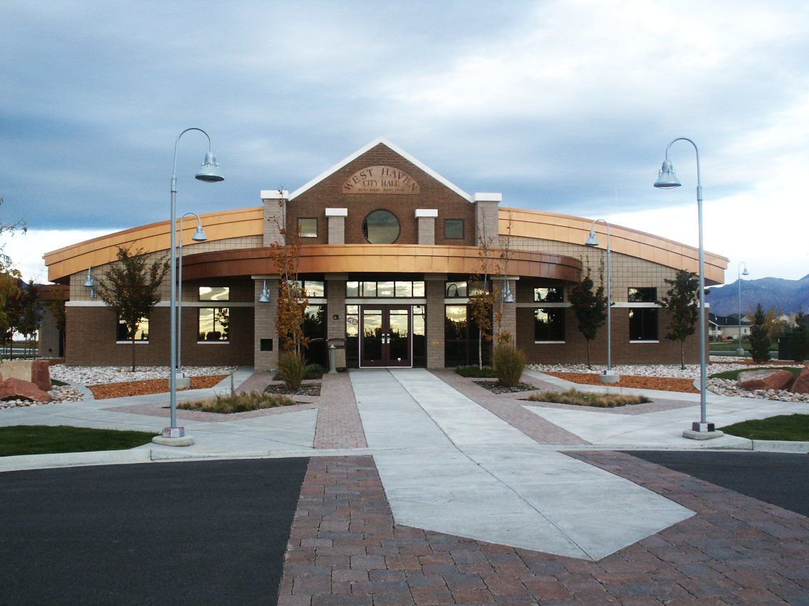 West Haven City Hall, a brick building with a curved front and lamp posts along the walkway