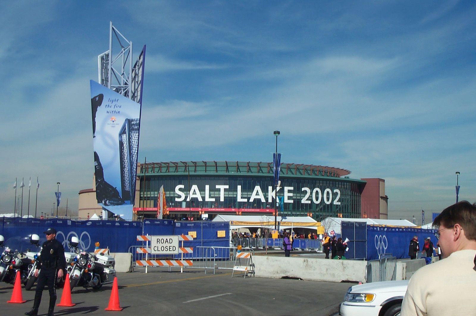 Police and crowd barriers outside the arena under Salt Lake 2002 Olympic banners